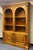 Ethan Allen Legacy double-arch bookcase features classic fluted pilasters, Corinthian-style carved capitals, and two lower...
