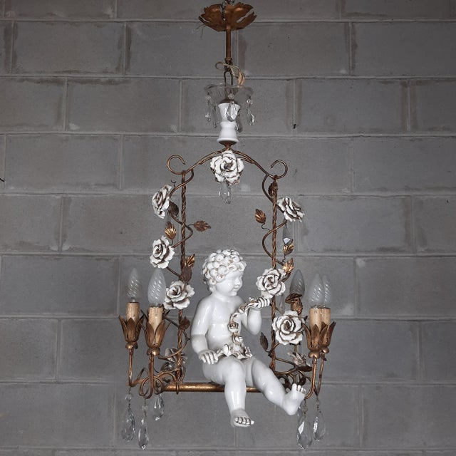 An elegant vintage chandelier in a romantic Baroque style, crafted with meticulous Florentine craftsmanship. At the center...