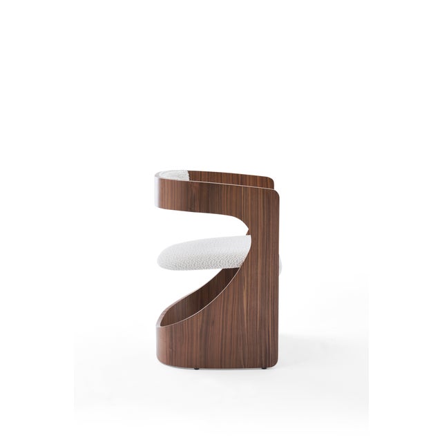 The Qs Dining Chair is a seamless fusion of contemporary design and organic elegance. Its gracefully curved solid wood...