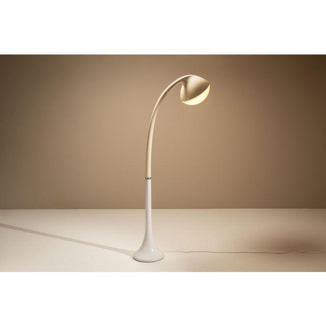 With its sculptural silhouette and fluid motion, this floor lamp captures the elegant experimentation of italian lighting...