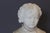 Alabaster bust of a young boy in 18th century clothing, rotating base, late 19th century, overall in good condition