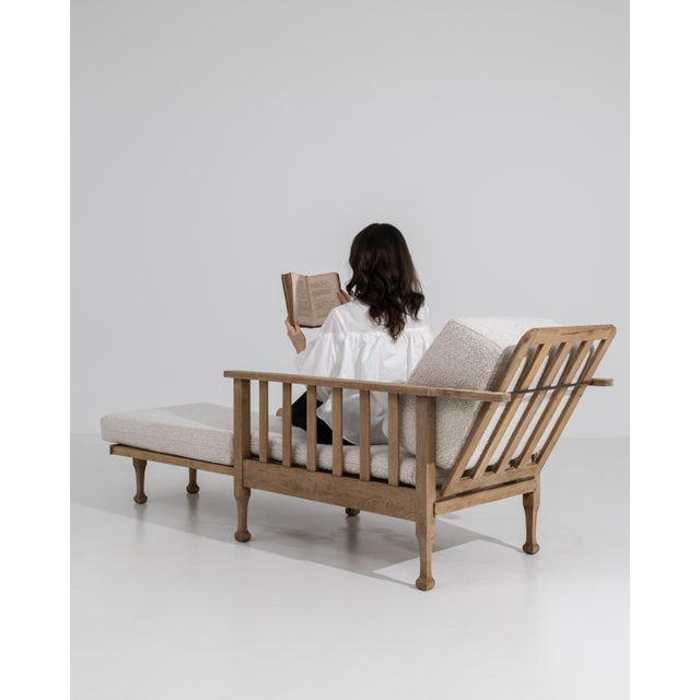 A mid-20th century lounge armchair featuring a reclining backrest and integrated pull-out footrest, combining structured...