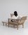 A mid-20th century lounge armchair featuring a reclining backrest and integrated pull-out footrest, combining structured...