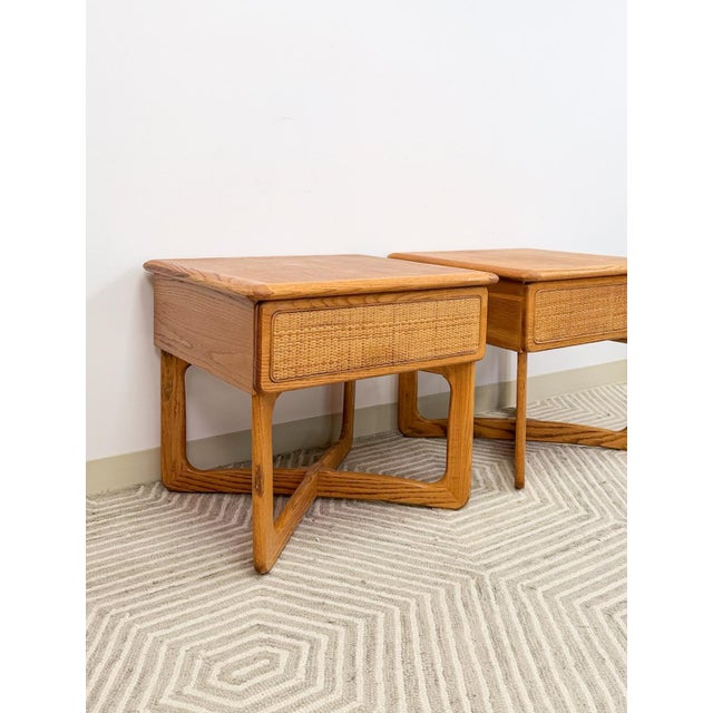 These charming Lane "Perception" mid-century modern oak nightstands with "x" pattern base are a beautifully crafted and...