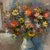 A oil on canvas painting by Italian artist Giuseppe Bertolini a still life portrays a bedroom setting of a floral boquet...