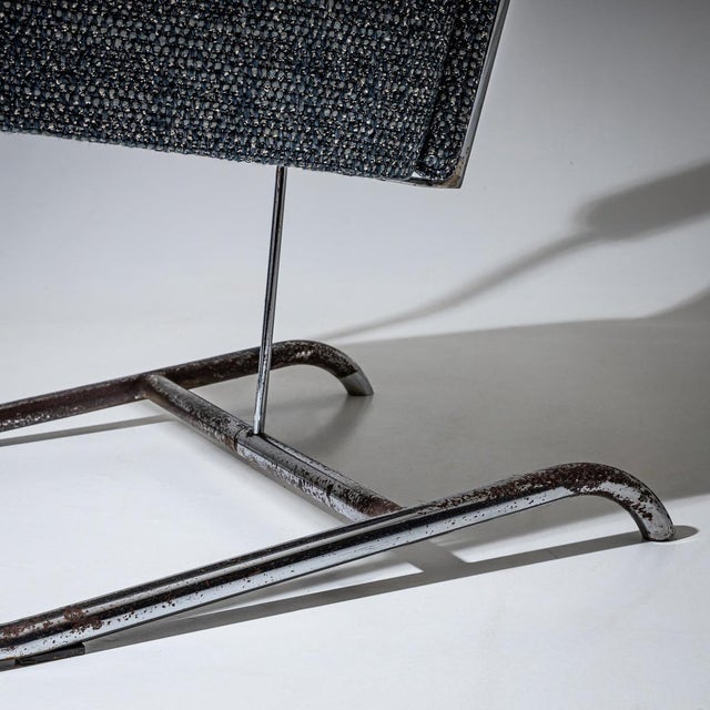 Italian Mid-Century armchair featuring a chrome-plated cantilevered tubular metal frame. The padded seat and backrest...