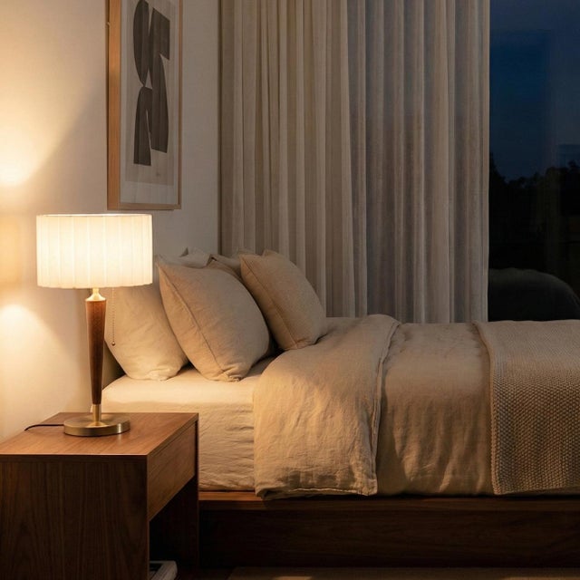 Crafted out of dark walnut and cold-rolled seel with weathered brass hardware, Scallop Table Lamp features a mid-century...