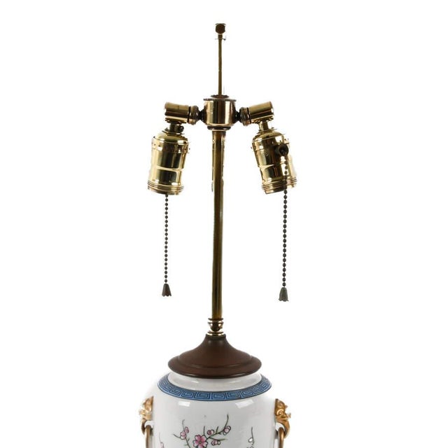 This porcelain floral and Greek key design table lamp is a striking blend of decorative artistry and timeless classical...