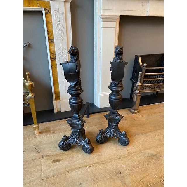 A substantial pair of fire dogs. The shield baring bears on hind legs supported on tripod scrolled acanthus feet. A very...