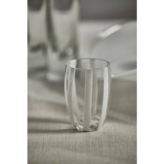 This lovely stemless glass is a stunning work of art. The shape is a classic tapered cylindrical shape, but the design of...