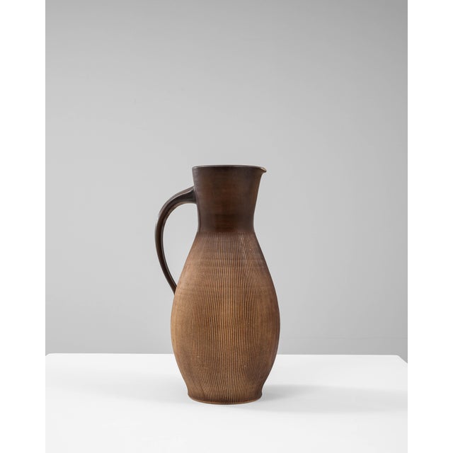 This 20th Century German ceramic jug exemplifies the refined simplicity of mid-century European pottery. Crafted with a...