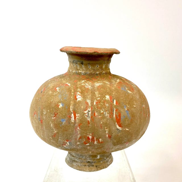 This is a Chinese Han Dynasty (206 BC-AD 220) to cocoon jar. This rounded oblong body is surmounted by a circular neck...