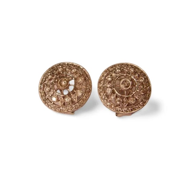 Antique earrings crafted in 18K white gold, featuring rose cut and single cut diamonds set in a delicate filigree cluster...