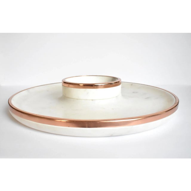 A Williams-Sonoma carved white marble large round platter and removable center bowl, or "chip and dip", with copper borders.