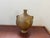 Handcrafted vintage Moroccan ceramic vessel with two applied loop handles and a rich, mustard yellow glaze showing earthy...