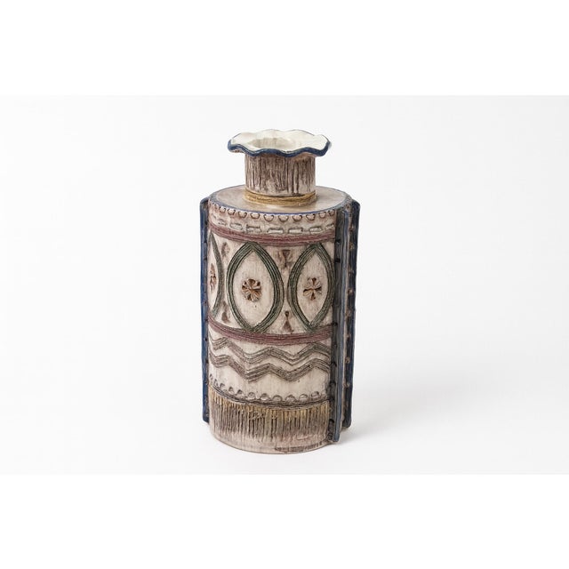 A striking Italian vase with intricate sgraffito geometric carving. Blue accent trims define the form, while an undulating...