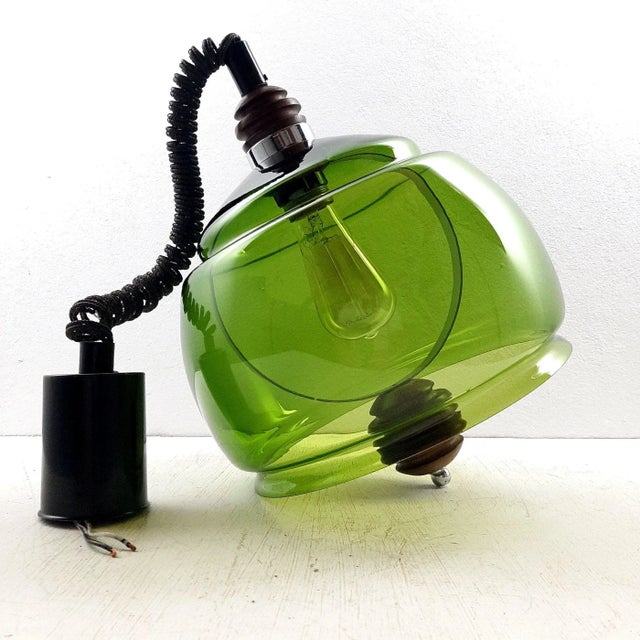 The unusually beautiful pendant lamp was produced in Yugoslavia at the manufactory Sijaj Hrastnik in the 60s. The green...