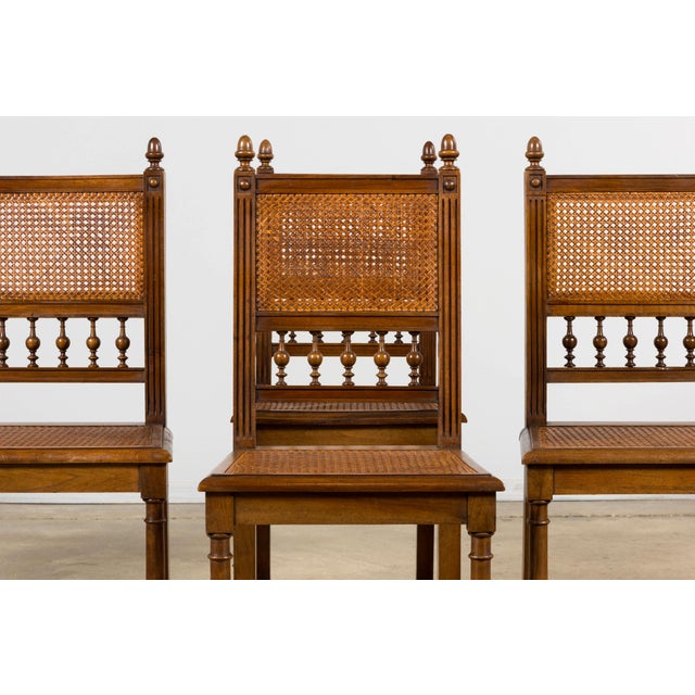 Antique set of eight French Henri II style dining chairs crafted in walnut with hand-caned seats and backs, sourced in...