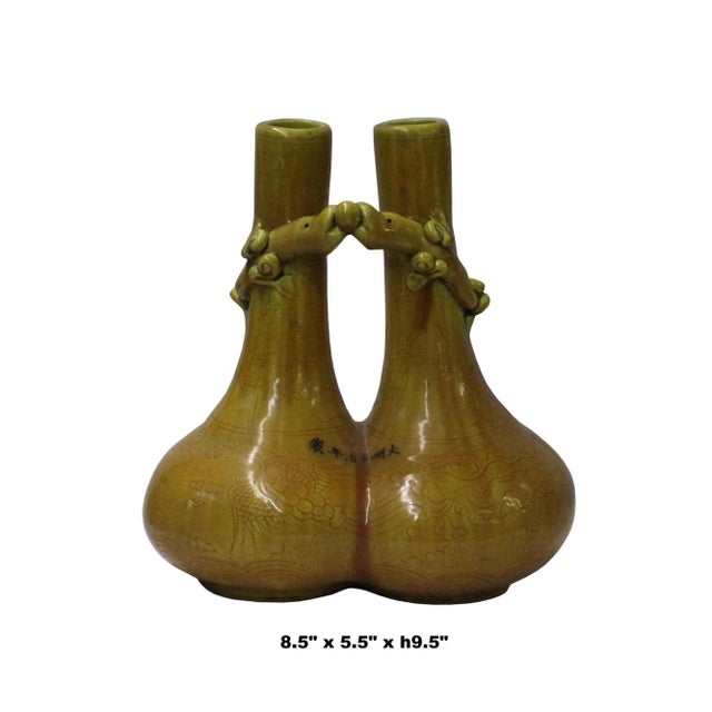 This is a handmade Chinese accent decorative double mouth vase made of ceramic. The surface has a relief dimensional...