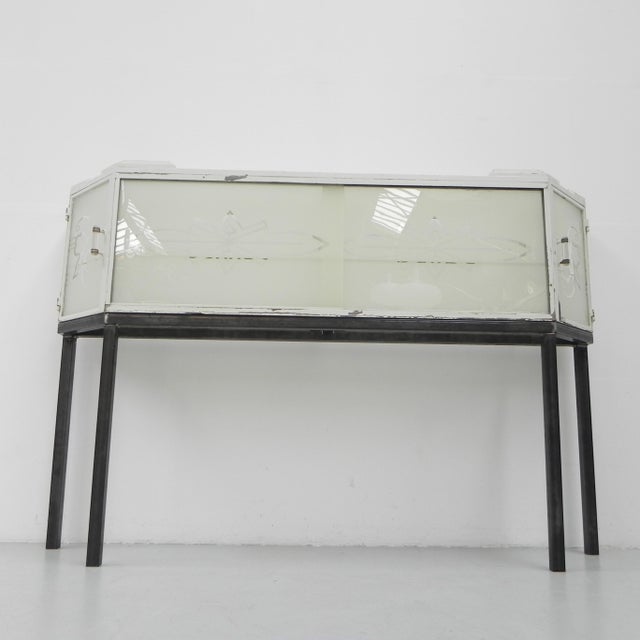 The white display case originally has hung against the wall in a butcher's shop. We have made a separate frame for it so...