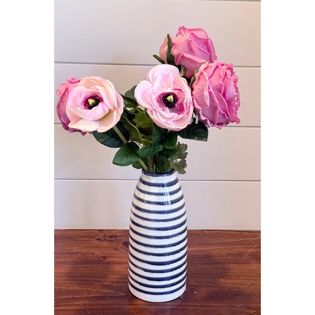 Soft, romantic and effortlessly refined - this arrangement features full fuchsia-pink peonies in pink bloom, artfully...