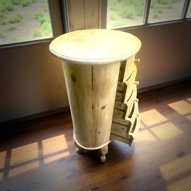 A charming and unique hand-crafted wooden accent chest featuring an artistic curved silhouette, soft rounded top, and...