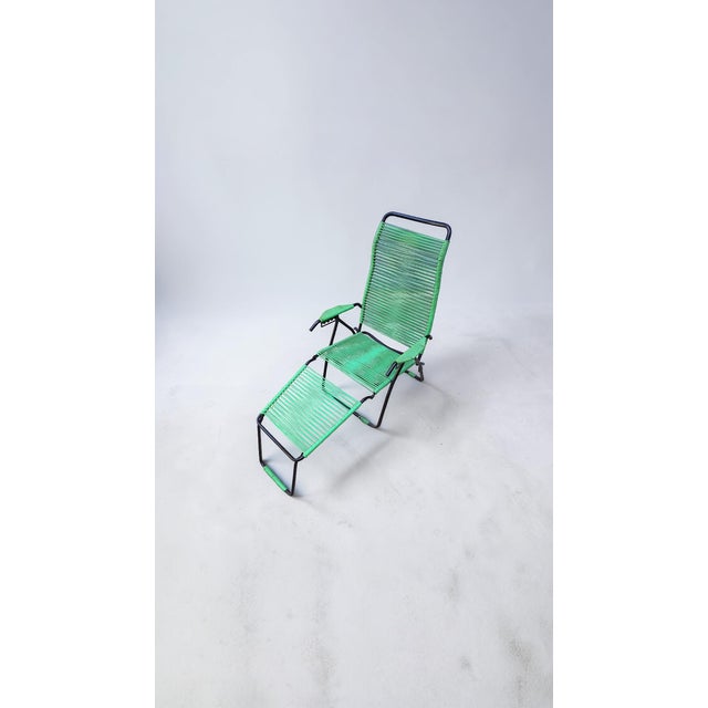 Outdoor lounger, designed and manufactured in the 1960s. Black painted metal frame, seat and backrest made of green PVC...