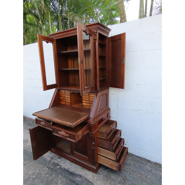 This rare Secretary Desk is made out of wood, solid wood, walnut, burlwood, veneer, and glass. It has a Victorian Eastlake...