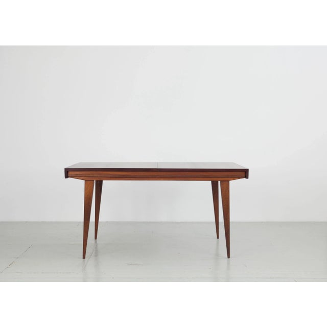 This table was designed in France in the 1950s by Maurice Pré. The table is made of mahogany and has an extendable table...