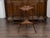 An English Regency period mahogany guéridon table from the early 19th century, with pie crust tray top, tripartite shelf...