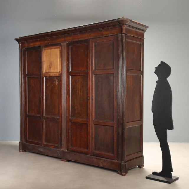 Louis Philippe walnut wardrobe from Italy, second quarter of the 19th century, featuring a solid structure and refined...