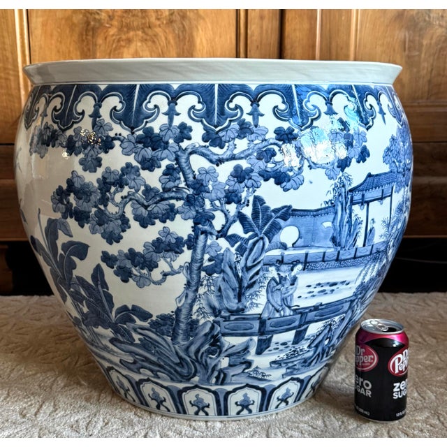 Beautiful large Chinoiserie blue and white porcelain cachepot featuring a continuous hand-painted landscape scene with...