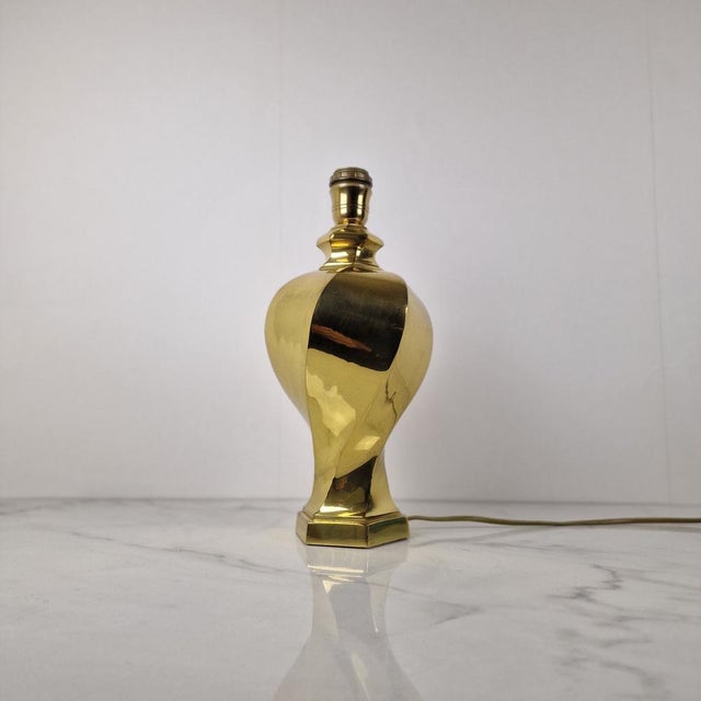 This striking table lamp features an elegant sculptural base crafted from solid brass. The organically curved form and...