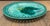 Vintage Majolica style serving dish with slotted rim. Glazed green ceramic with fern motif in different shades of green.