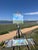 Bow Mar Skies by Michael Magrin | Oil on Linen Landscape with blue sky and grassy fields For Sale