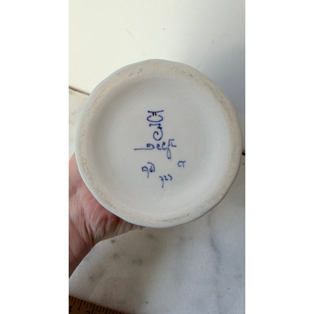An exceptional and highly collectible mid-century hand-painted Delft Blue ceramic pedestal vase from the world-renowned De...