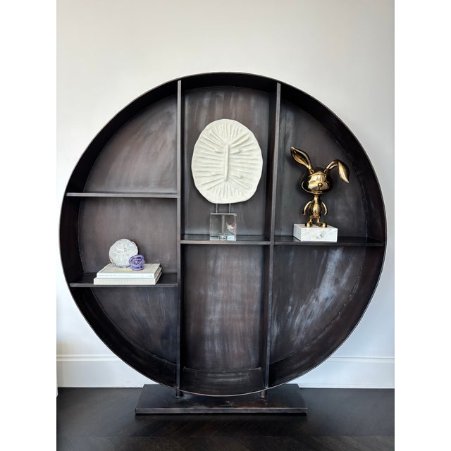 Stunning and dramatic sculptural circular iron shelving unit that serves as a striking focal point. This designer-quality...