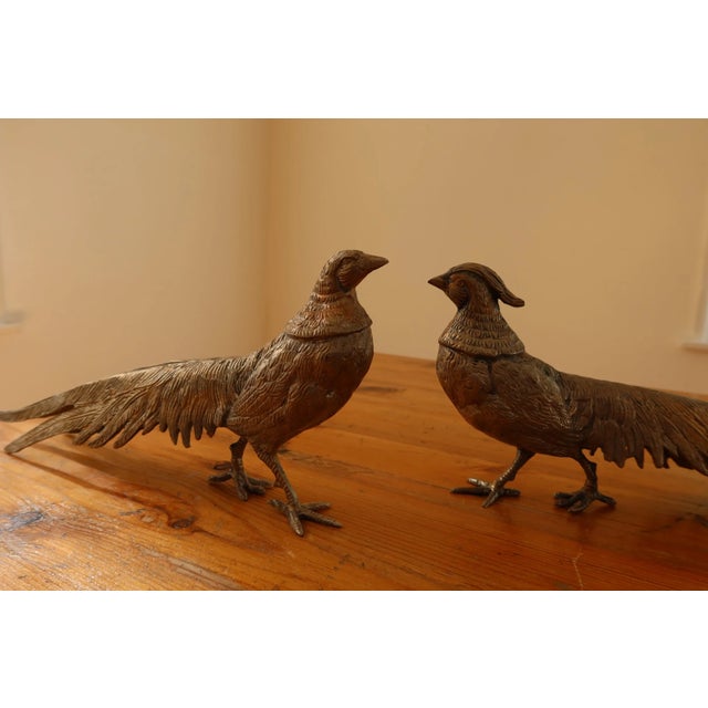 Pair of antique silverplate male and female pheasants.