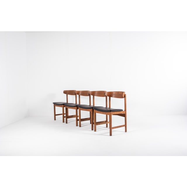 Set of four Danish mid-century modern oak dining chairs from the 1960s. The chairs feature a timeless Scandinavian design...