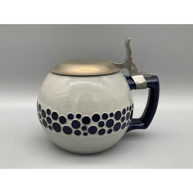 Two beer mugs *with a tin lid *0.5 l *Stoneware/ ceramic *Referred, blue glazed dot pattern *On the underside, Reinhold...