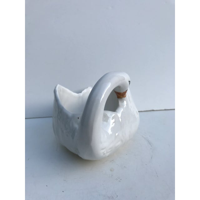 This is a delicate beauty. It is all white with feathers and the only colors are hand painted on the top of the head, the...