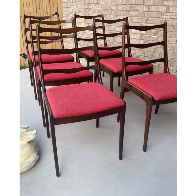 C. 1960s mid century modern Danish rosewood set of six dining chairs, attributed to Johannes Andersen. No identifiable...