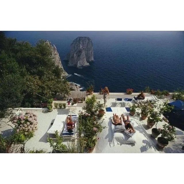 Il Canille 1980 by Slim Aarons Slim Aarons Limited Estate Edition Sunbathers lounge on the white-painted terrace of Il...