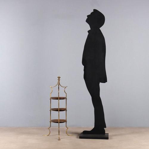 Elegant 3-tier brass and wood storage rack. This piece is attributed to the mentioned designer/maker. It has no...