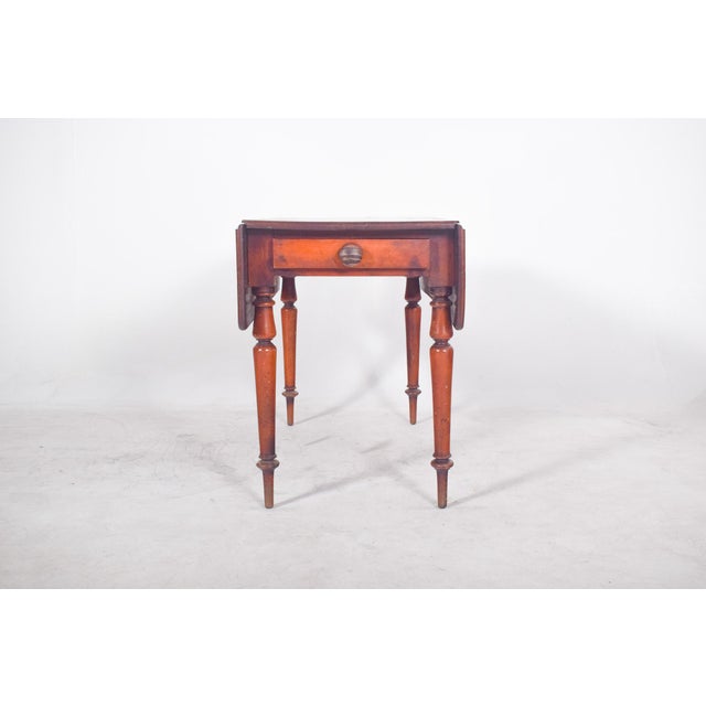 Side table with drawer. Made from solid wood and finished in a dark colour, the table stands out for its practicality and...