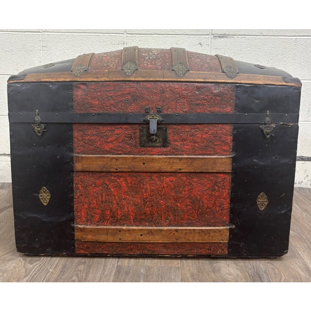 This is a striking antique Victorian dome-top immigrant or steamer trunk dating to the late 1800s. It features richly...