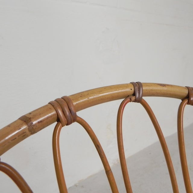 Set of 2 vintage chairs with 2 bamboo circles connected by rattan stems. Black lacquered steel frame. Height: 71 cm....