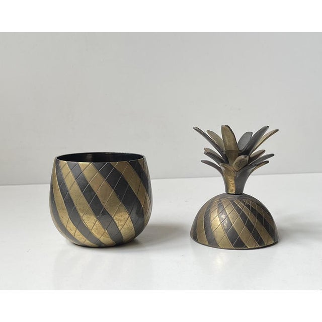 A vintage brass sculptural pineapple trinket that incorporates the playful glamour of the Hollywood Regency era and style....