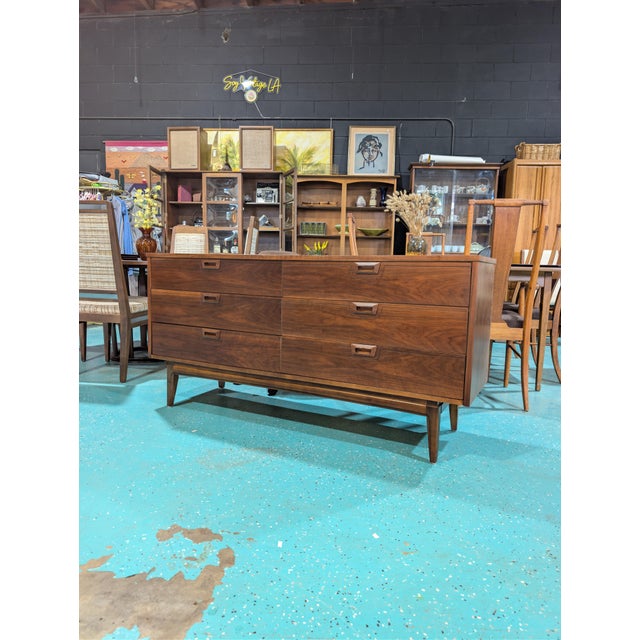 Expertly crafted, the Mid-Century Walnut Lowboy Dresser , by United, makers mark on the inside drawer exemplifies timeless...