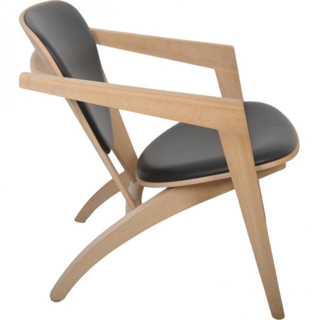 Hans Wegner GE460 Butterfly chair with a frame of oak and back and seat upholstered in black leather. The chair is from...